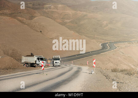 Road works. Asphalt removing machine loading powdered asphalt on the truck Stock Photo