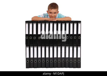 The boy bases on many big black folders on a white background Stock Photo