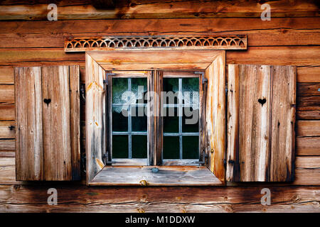 Old window shutter with heart. Rustic wooden house, simple courtains Stock Photo