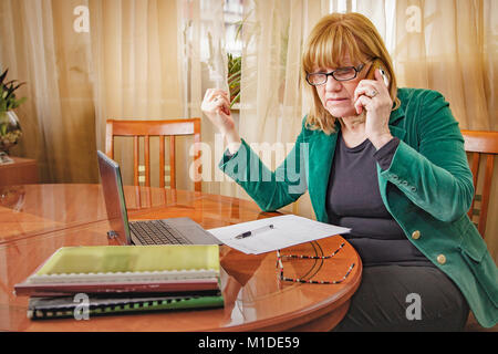 Elderly lady discussing some serious matters Stock Photo