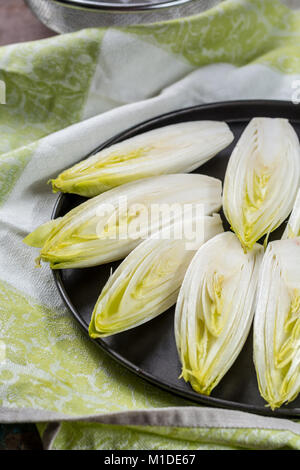 Fresh raw Belgian bitter chicory salad ready to cook, close up Stock Photo