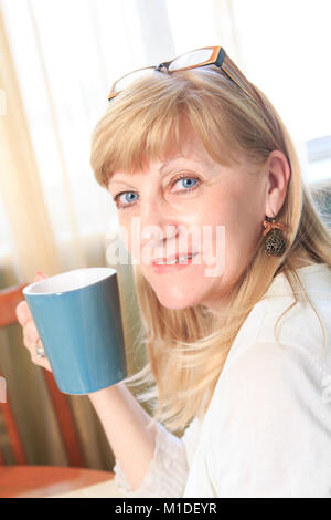 Happy senior lady with a cup of coffee Stock Photo