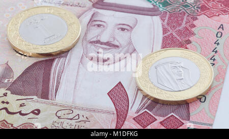 Saudi Riyal 100 Banknote and New Coin showing King Salman of Saudi Arabia Stock Photo