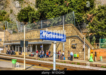 Travelers wait for the next train at the Monterosso al Mare train station in Cinque Terre, Italy on the Ligurian coast Stock Photo