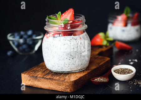Chia pudding with fresh berries in a jar. Selective focus. Cleansing, dieting, healthy eating, fitness menu concept Stock Photo