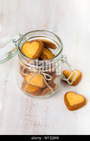 Heart-shaped cookies in a glass jar on St. Valentine's Day. Greeting card for St. Valentine's Day Stock Photo
