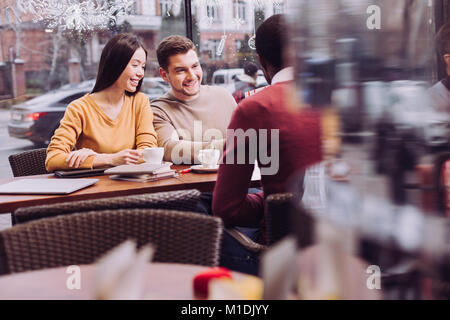 Pretty three colleagues explaining their vision Stock Photo