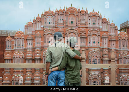 Jaipur, India - Jul 27, 2015. A young couple standing and looking at Hawa Mahal (Wind Palace) in Jaipur, India. Stock Photo