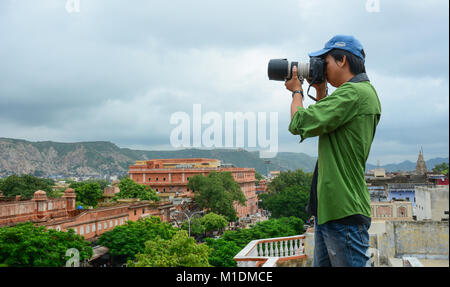 Jaipur, India - Jul 27, 2015. A young photographer taking pictures cityscape of Jaipur, India. Stock Photo