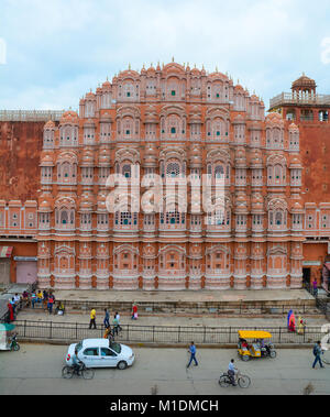 Jaipur, India - Jul 27, 2015. Traffic on main street with Hawa Mahal (Wind Palace) in Jaipur, India. Stock Photo