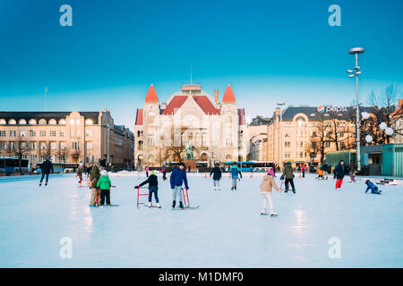 Helsinki, Finland - December 10, 2016: Children Skating On Rink On Railway Square On Background Of Finnish National Theatre In Winter Sunny Day. Stock Photo