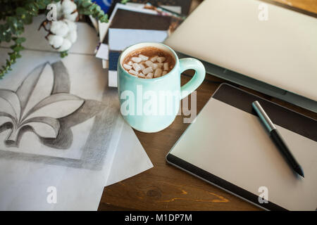 Artistic Workplace with Graphic Tablet, Drawing, Laptop and Coffee Cup Stock Photo
