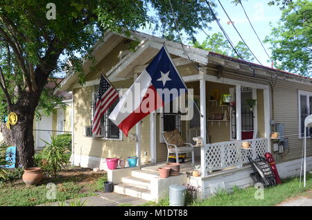 a house in dignowty hill san antonio flying the texas and USA flags Stock Photo