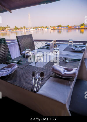 Restaurant table with empty glasses and basic dining set at Goa Restaurant Stock Photo