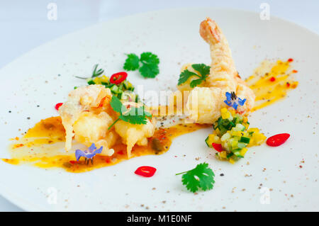 Fried shrimp in the cradle with spicy sauce. Stock Photo