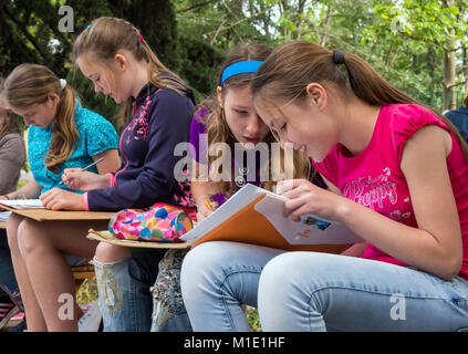 Alushta, Russia - June 09, 2016: A group of girls engaged in drawing outdoors Stock Photo