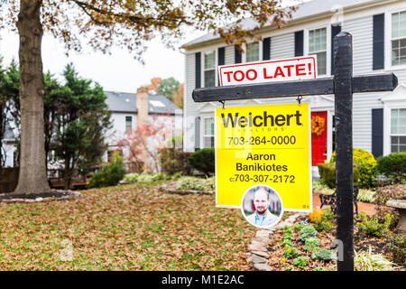 Herndon, USA - November 9, 2017: Too late real estate home buyer sign in front of house in Fairfax County, Virginia neighborhood with realtor name num Stock Photo