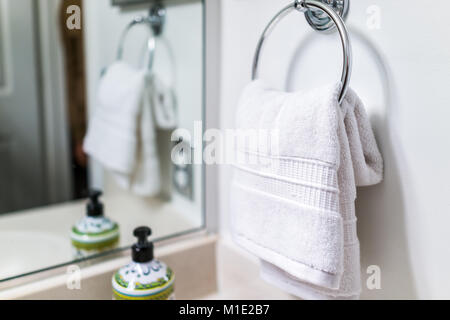 Staging modern bathroom with one decorated towel hanging on rack by sink in model home, apartment or house Stock Photo
