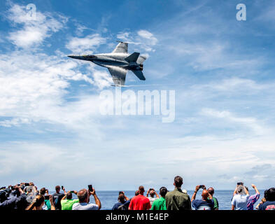 ATLANTIC OCEAN (Aug. 20, 2017) Sailors and guests watch an F/A-18E Super Hornet attached to the 'Tomcatters' of Strike Fighter Squadron (VFA) 31 during an air power demonstration for a Tiger Cruise aboard the aircraft carrier USS George H.W. Bush (CVN 77). The ship and its carrier strike group are transiting home from a scheduled seven-month deployment in support of maritime security operations and theater security cooperation efforts in the U.S. 5th and 6th Fleet areas of responsibility. (U.S. Navy Stock Photo