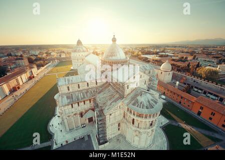 Cathedral viewed from top of Pisa leaning tower at sunset wide angle view Stock Photo