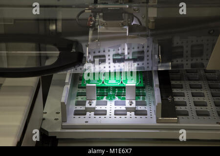 PCB loading / unloading for in-line PCB router Stock Photo