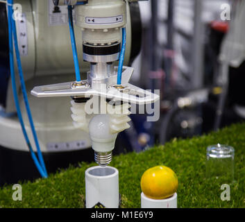 Robotic arm demonstration lifting light bulb and put on pipe Stock Photo