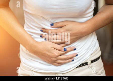 Woman stomach pain due to disease Stock Photo