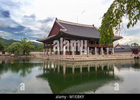 SEOUL, SOUTH KOREA ,SEPTEMBER 12, 2015: building surrounded by pond at Gyeongbokgung Palace on cloudy day Stock Photo