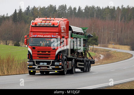 SALO, FINLAND - JANUARY 26, 2018: Customized 4-series Scania truck hauls machinery along rural highway in South of Finland. Stock Photo