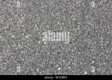 Asphalt concrete roadway pavement surface. Grey background. Stock Photo