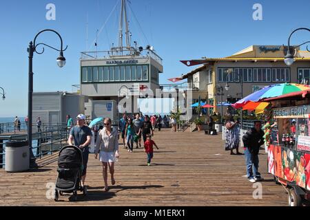 SANTA MONICA, UNITED STATES - APRIL 6, 2014: People visit the pier in Santa Monica, California. As of 2012 more than 7 million visitors from outside o Stock Photo