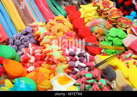 Confectionery shop at Boqueria market in Barcelona, Spain. Colorful gumdrops and wine gum sweets. Stock Photo