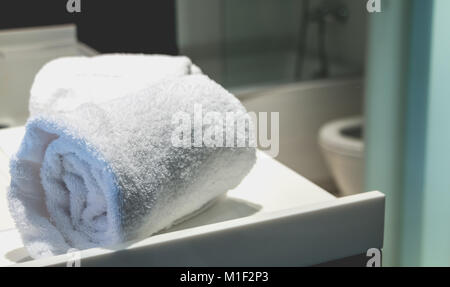bath towel rolled on a sink in a bathroom in spain Stock Photo