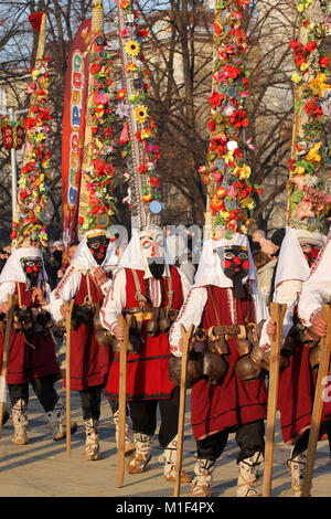 Kukeri, mummers perform rituals with costumes and big bells on international festival of masquerade game 'Surva' in Pernik, Bulgaria, Jan 2018 Stock Photo