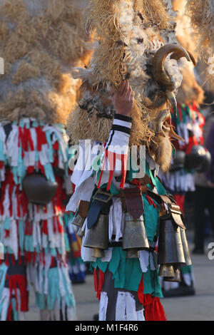 Kukeri, mummers perform rituals with costumes and big bells on international festival of masquerade game 'Surva' in Pernik, Bulgaria, Jan 2018 Stock Photo