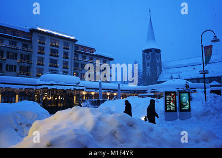 Downtown Zermatt in winter snowing record snowfall, Church and Grand Hotel Zermatterhof, Valais, Switzerland Stock Photo