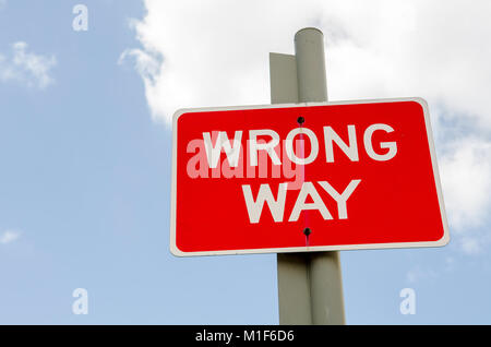 Wrong Way road sign post. Poor decision making, bad planning and disastrous ideas Stock Photo