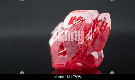 Red natural crystal mineral on a black background Stock Photo