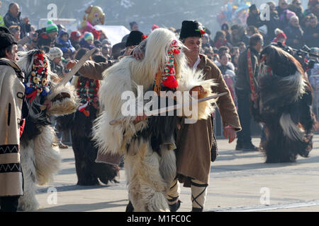 Kukeri, mummers perform rituals with costumes and big bells on international festival of masquerade game 'Surva' in Pernik, Bulgaria, Jan 2018 Stock Photo