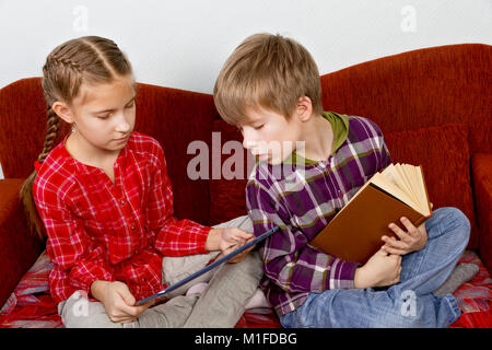 Modern and old sources of information. Children make lessons Stock Photo