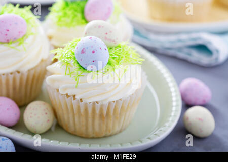 Easter vanilla cupcakes with cream cheese frosting and egg candy Stock Photo