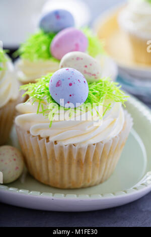 Easter vanilla cupcakes with cream cheese frosting and egg candy Stock Photo