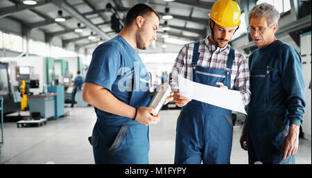 Team Of Engineers Having Discussion In Factory Stock Photo