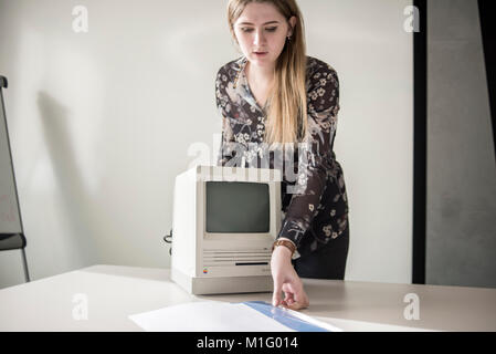 A member of staff shows Macintosh SE FDHD, release date August 1989, at MacPaw's Ukrainian Apple Museum in Kiev, Ukraine on January 26, 2017. Ukrainian developer MacPaw has opened Apple hardware museum at the company’s office in Kiev. The collection has more than 70 original Macintosh models dated from 1981 to 2017. Stock Photo
