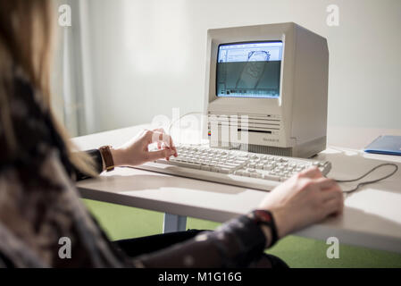 A member of staff shows Macintosh SE FDHD, release date August 1989, at MacPaw's Ukrainian Apple Museum in Kiev, Ukraine on January 26, 2017. Ukrainian developer MacPaw has opened Apple hardware museum at the company’s office in Kiev. The collection has more than 70 original Macintosh models dated from 1981 to 2017. Stock Photo