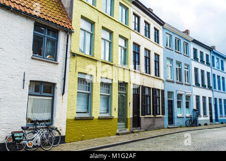 Bicycles parked in front of old colorful traditional houses on a street in the historic center of the medieval city of Bruges, Belgium Stock Photo