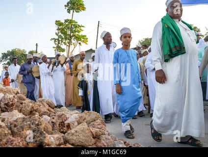 Sunni muslim people parading during the Maulidi festivities in the street, Lamu County, Lamu Town, Kenya Stock Photo