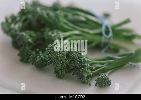 Brocollini on a white cutting board Stock Photo