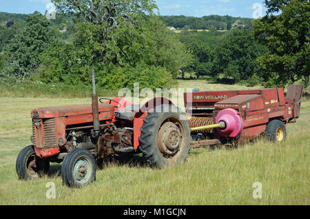 Massey Ferguson MF65 and New Holland baler Stock Photo