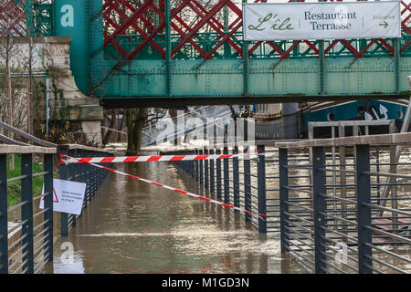 ISSY LES MOULINEAUX near PARIS, FRANCE - January 24, during the flood of winter, a billboard forbids access to the river where it is written - flooded Stock Photo